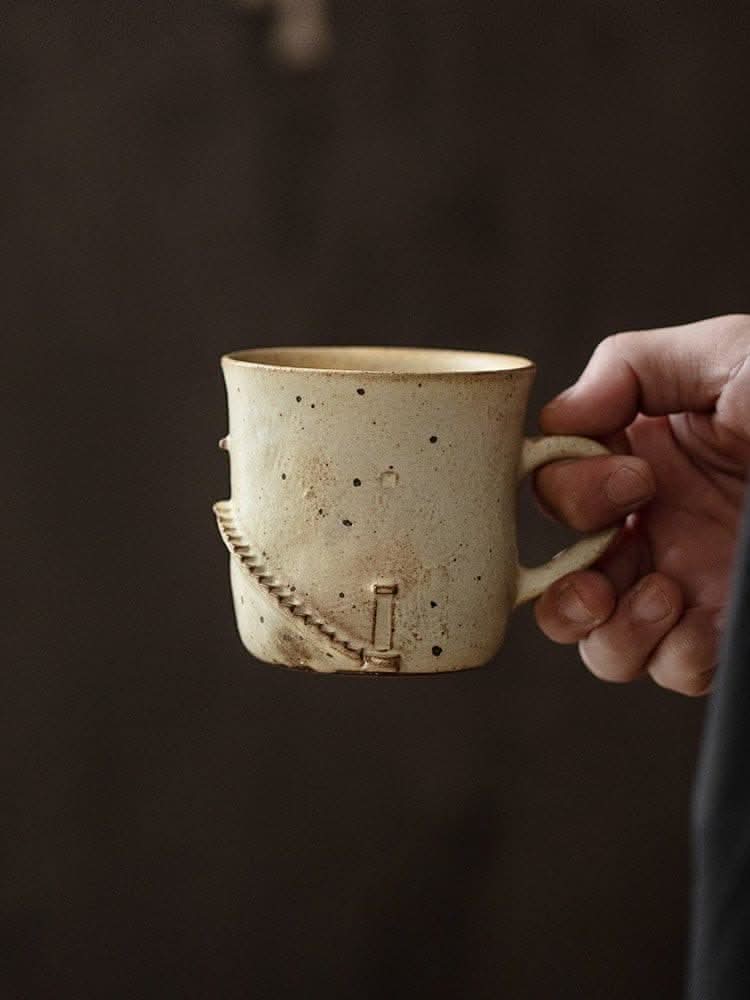 Hand-held beige Japan imported lighthouse stoneware mug with stairs design.